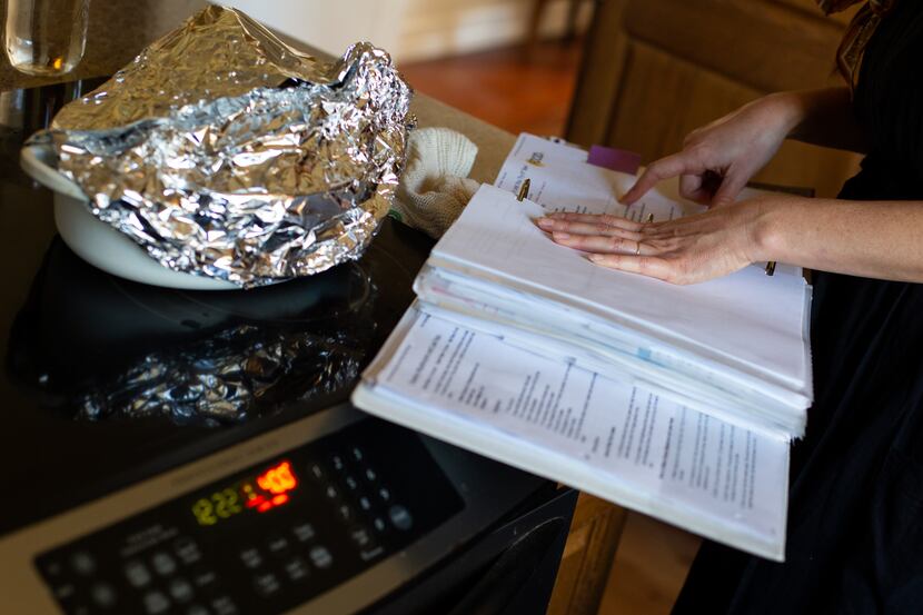 While her roasted chicken rests under foil, Jade Chessman flips through her recipe binder.