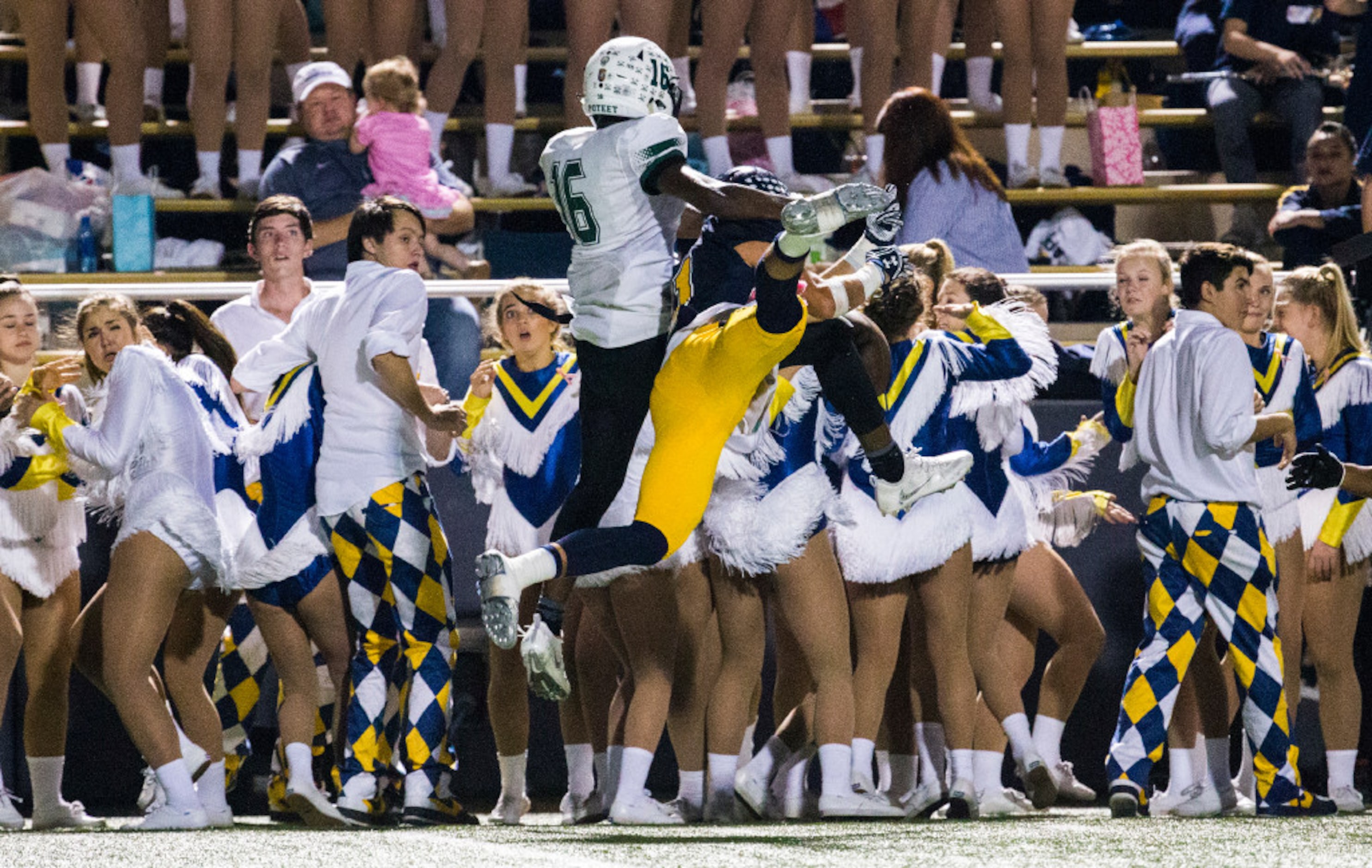 Highland Park cheerleaders react to Highland Park wide receiver Jack Toohey (11) and...