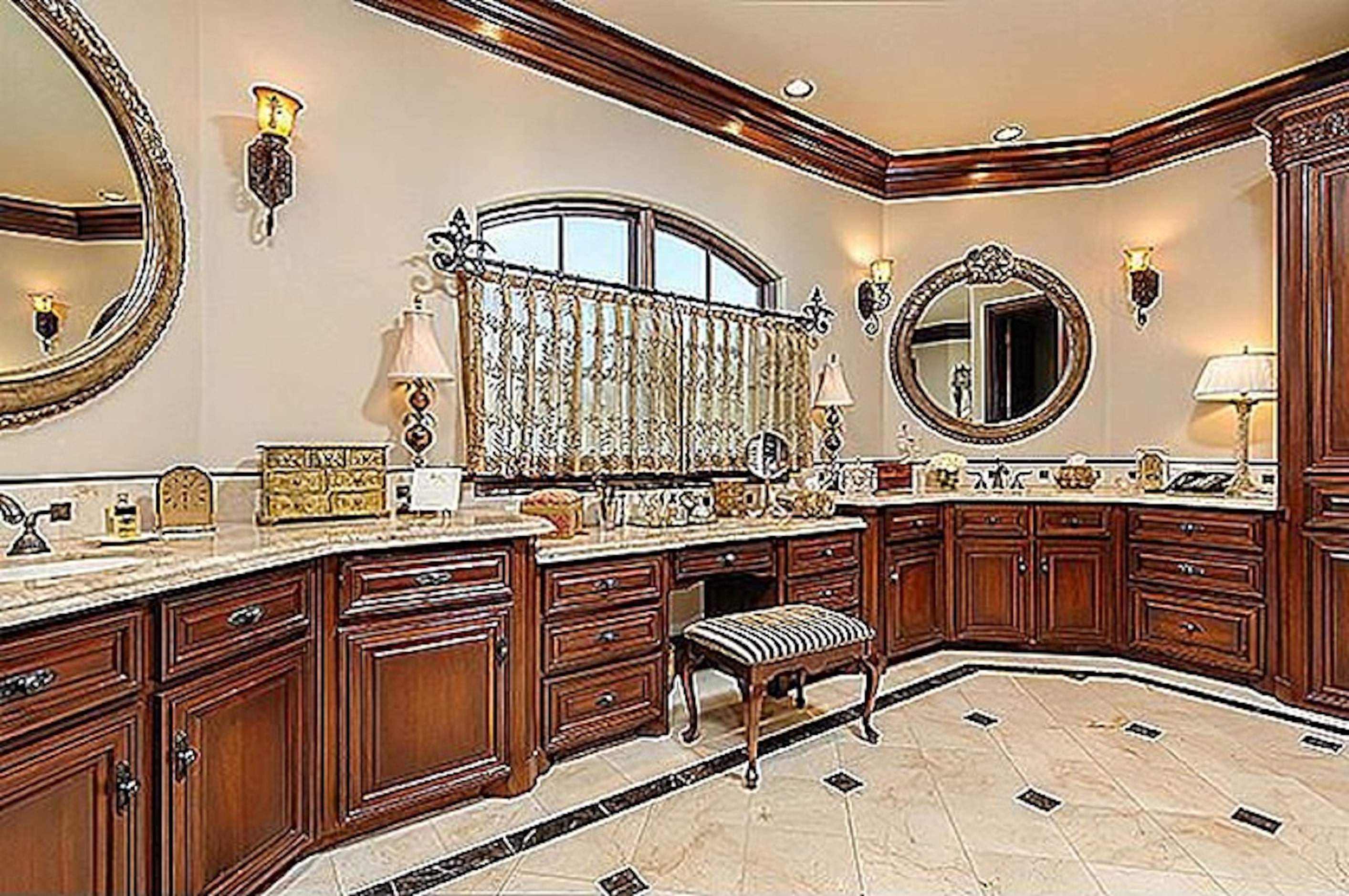 A view of the home's master bathroom which includes a hardwood and marble interior. 