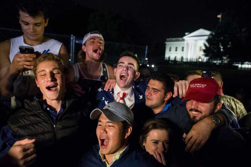 Supporters of Donald Trump celebrate outside the White House in the early hours of Wednesday...