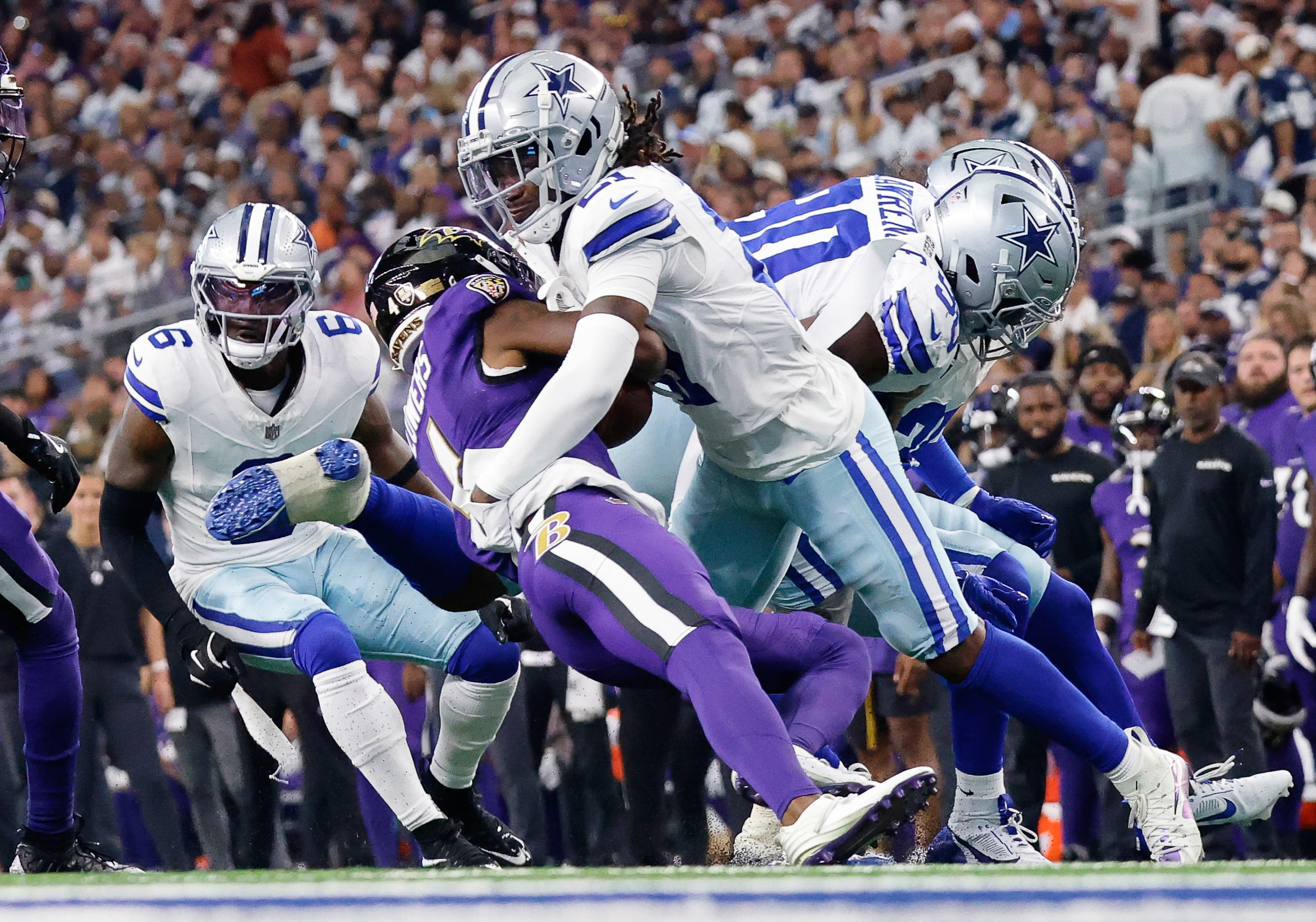 Dallas Cowboys cornerback Caelen Carson (21) tackles Baltimore Ravens wide receiver Zay...