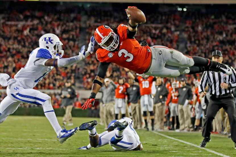 In this Nov. 23, 2013, file photo, Georgia running back Todd Gurley (3) dives into the end...