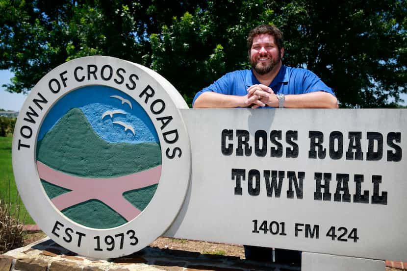 Mayor Steve Smith poses for a photo in front of the Cross Roads Town Hall sign, Wednesday,...