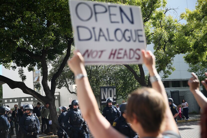 Anna Budd, of Oakland, who describes herself as "a classic liberal" holds a sign saying...