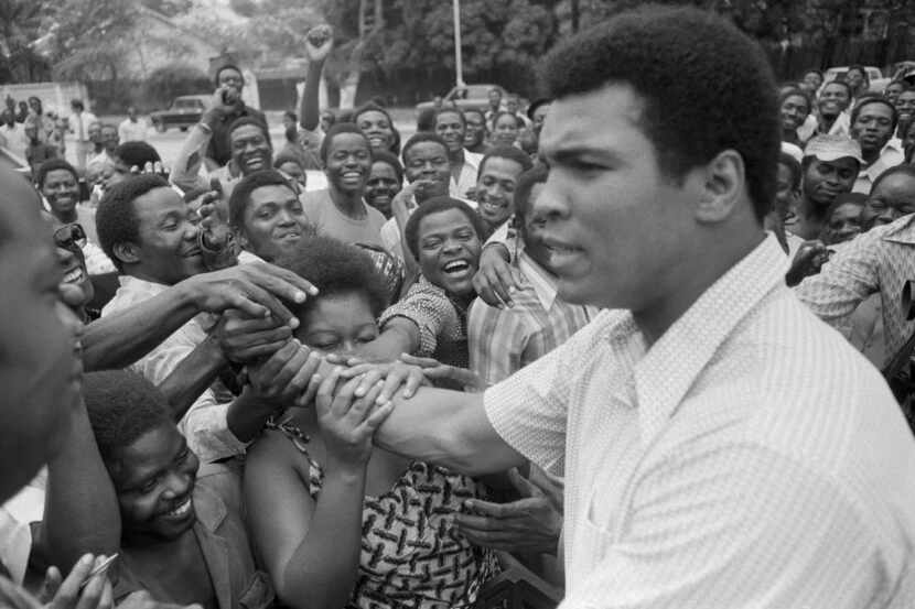 FILE - In this Sept. 17, 1974, file photo, Muhammad Ali is greeted in downtown Kinshasa,...