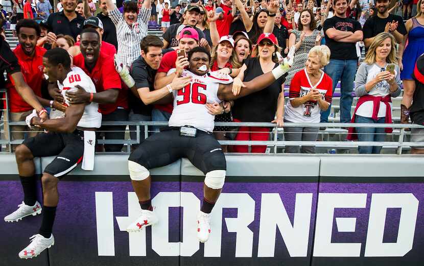 Texas Tech defensive lineman Broderick Washington (96) and wide receiver Michael Coley (80)...