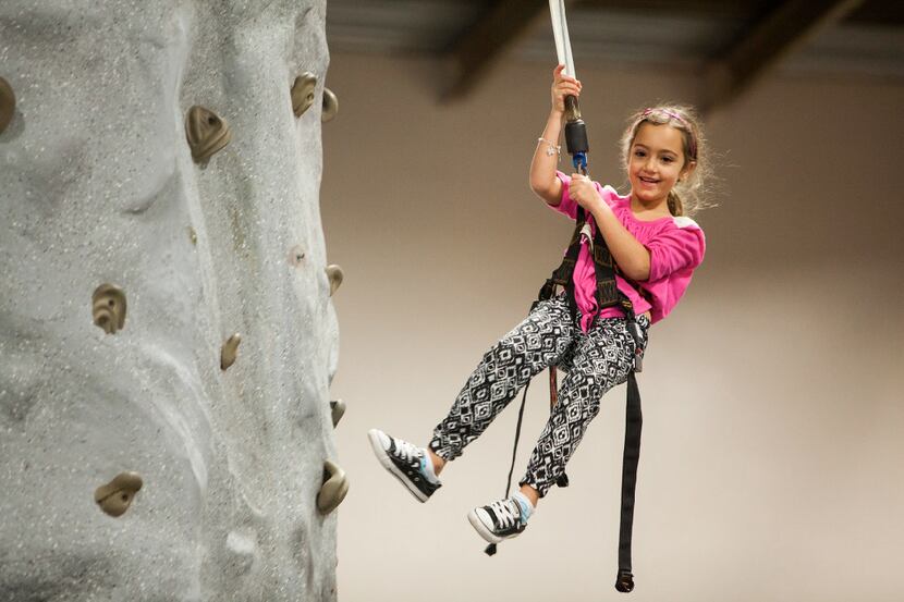 Part of the fun of scaling the rock wall is the ride down! Day 1 Dallas festival included a...