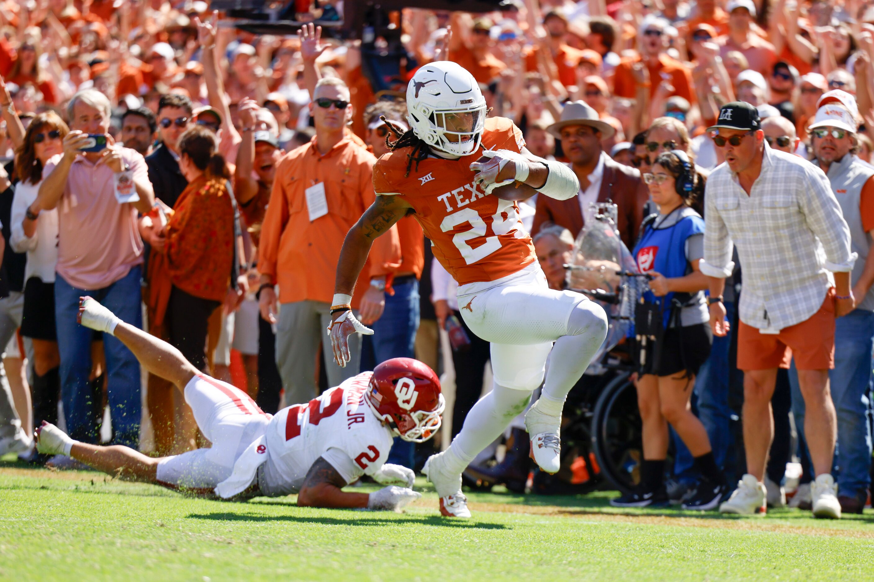 Oklahoma defensive back Billy Bowman Jr. (left) tries to tackle Texas running back Jonathon...