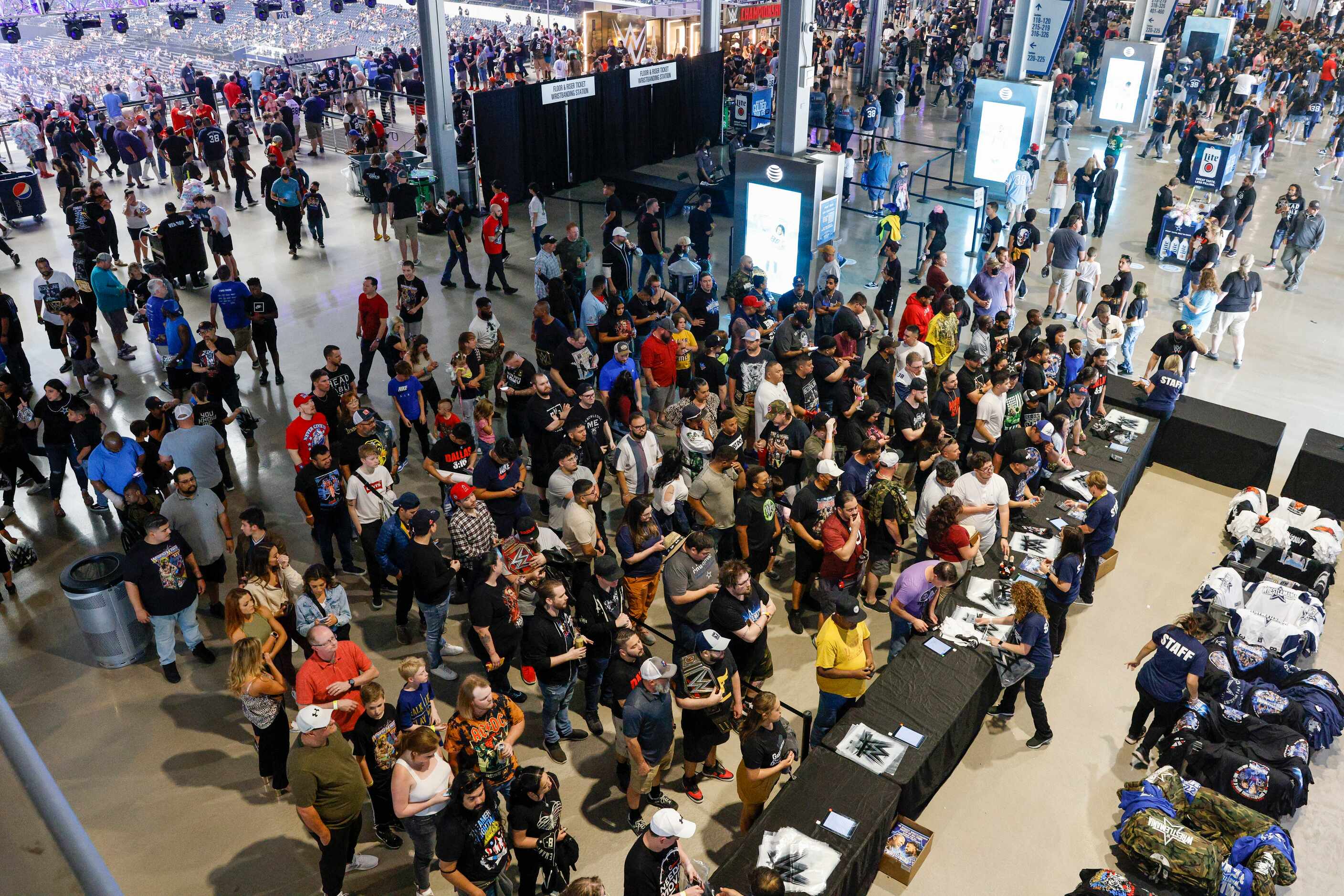 Wrestling fans wait to purchase merchandise before WrestleMania Sunday at AT&T Stadium in...