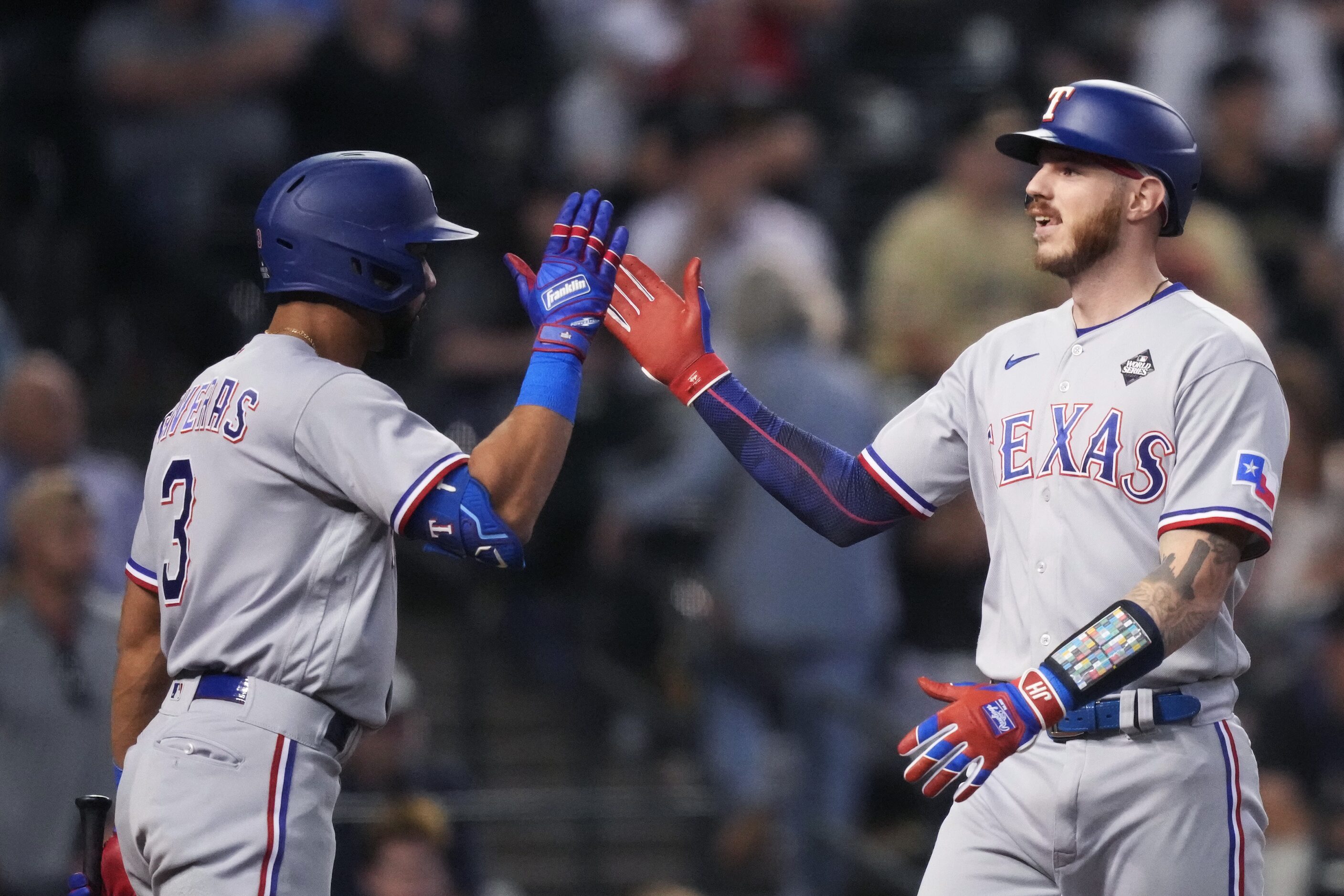 Texas Rangers’ Jonah Heim, right, is congratulated by Leody Taveras (3) after hitting solo...