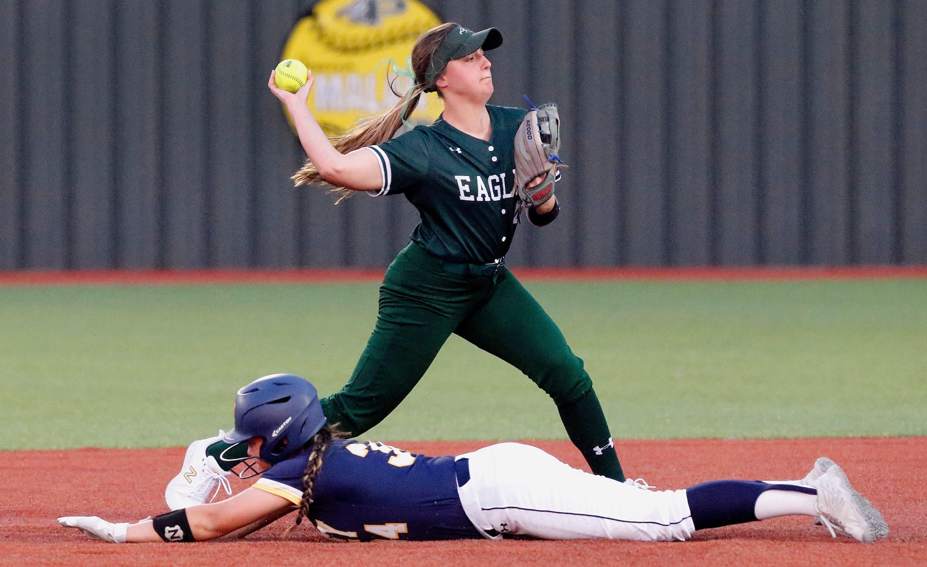 Prosper High School shortstop Abbey Beasley (11) makes the throw for a double play as...