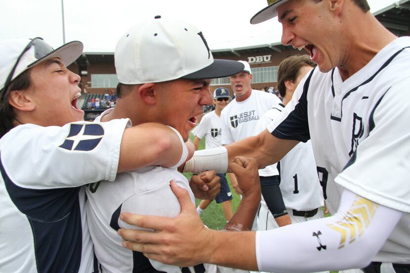 Jesuit starting pitcher JJ Montenegro (13), center, clinches his fist and lets out a yell as...