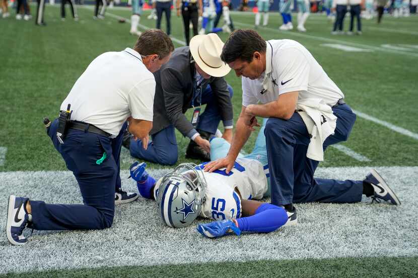 Dallas Cowboys linebacker DeMarvion Overshown is treated in the field during the first half...