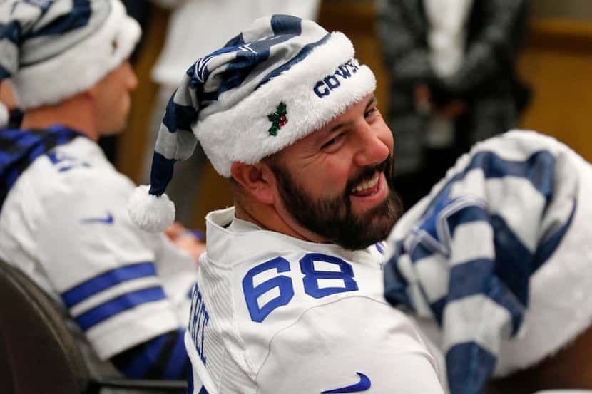 Dallas Cowboys tackle Doug Free (68) shares a laugh with a teammate as players and...