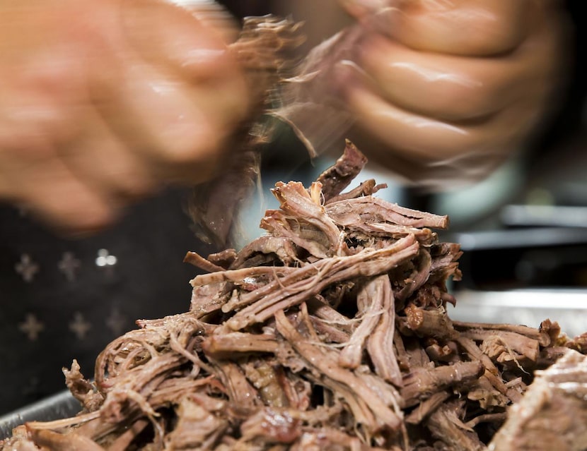 Monica Greene shreds brisket.