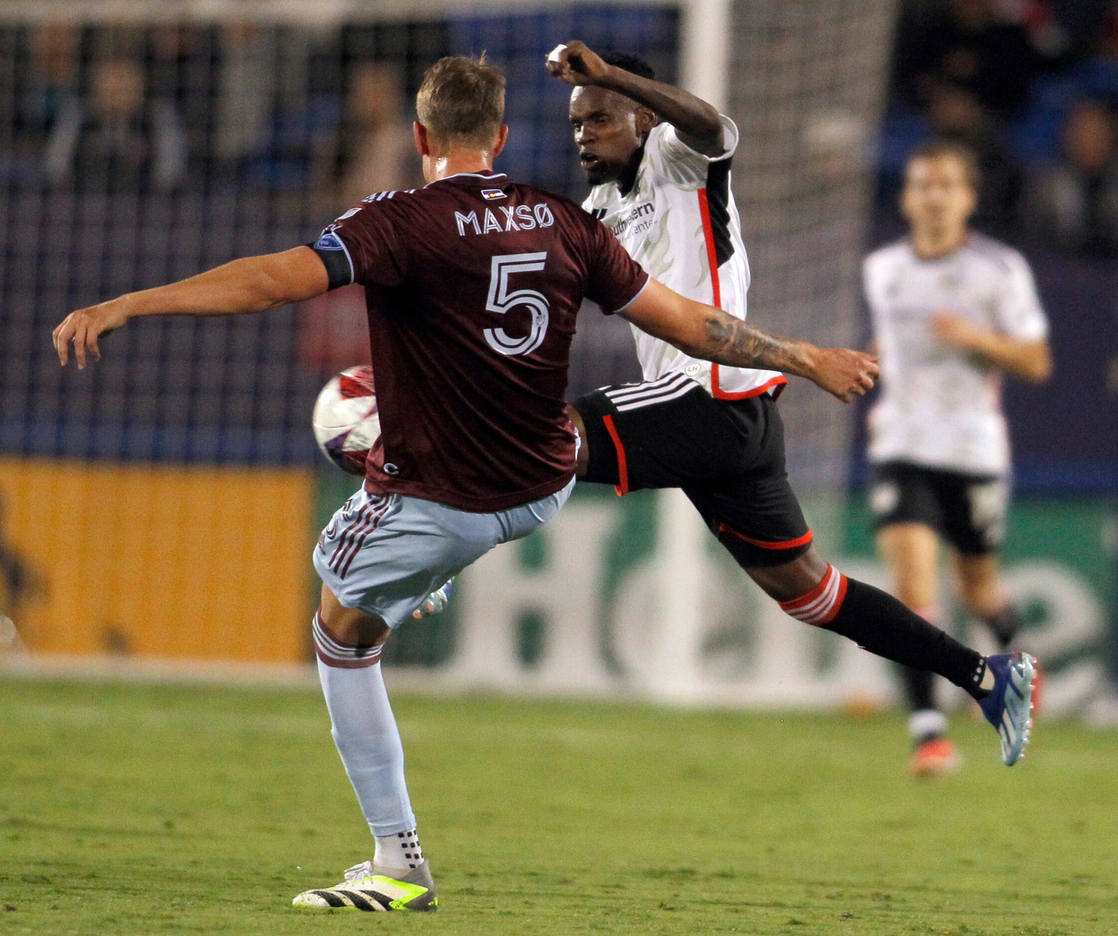 FC Dallas attacker Jader Obrian (8) flies to control the ball against the defense of...