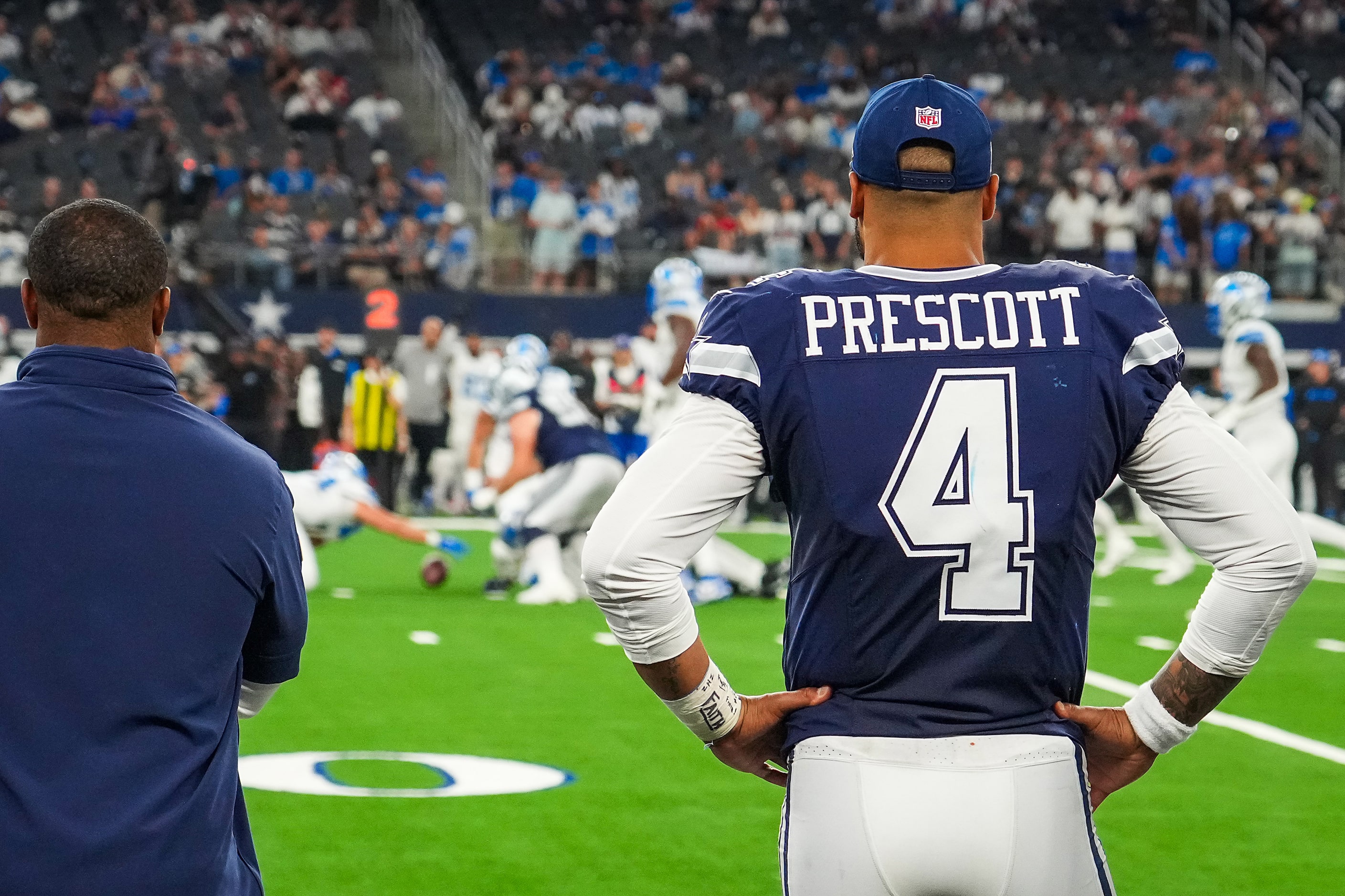 Dallas Cowboys quarterback Dak Prescott watches from the sidelines as the Detroit Lions...