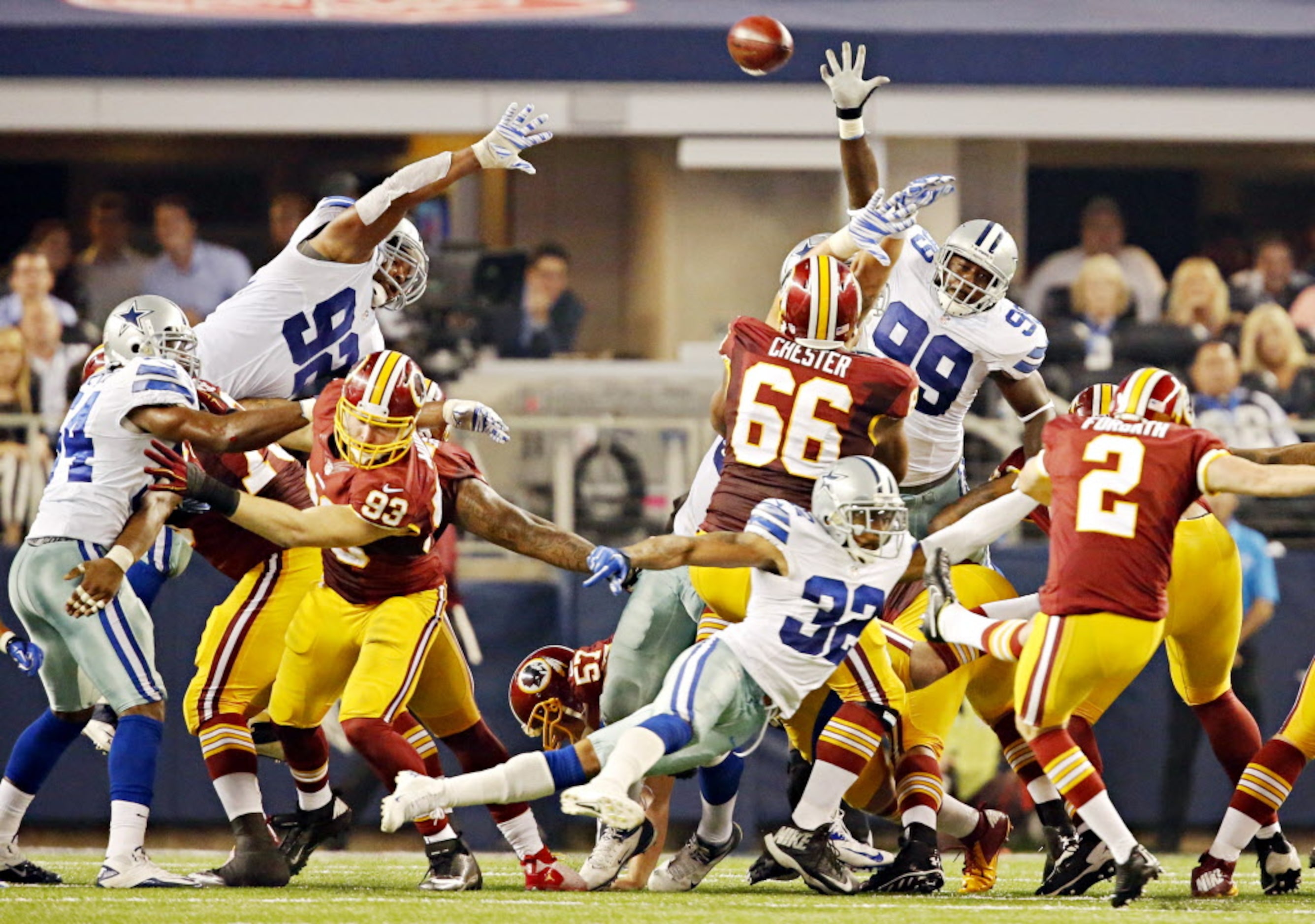 Dallas Cowboys defensive end George Selvie (99) can't block a punt by Washington Redskins...