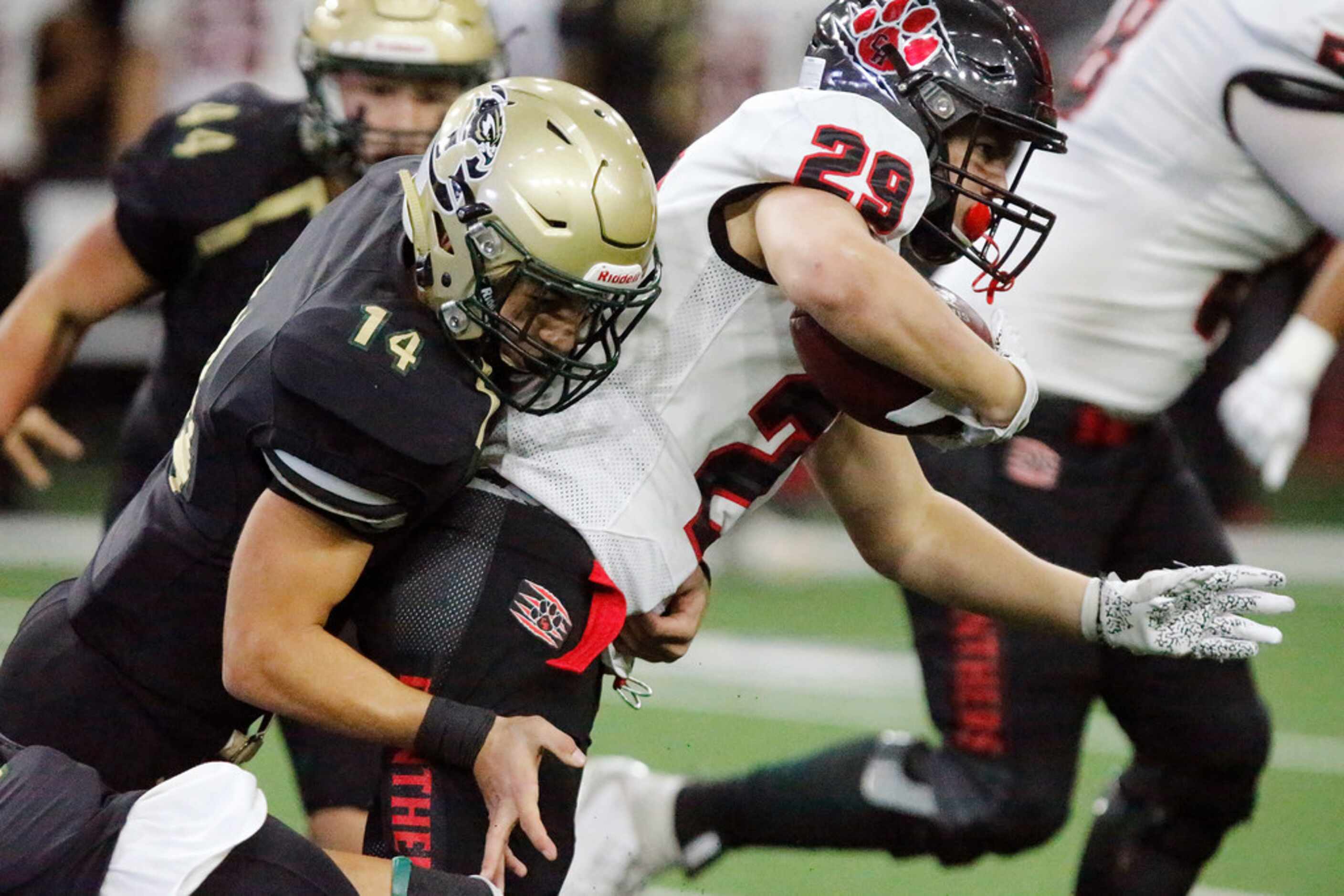 Colleyville Heritage High School running back Braxton Ash (29) is tackled by Birdville High...