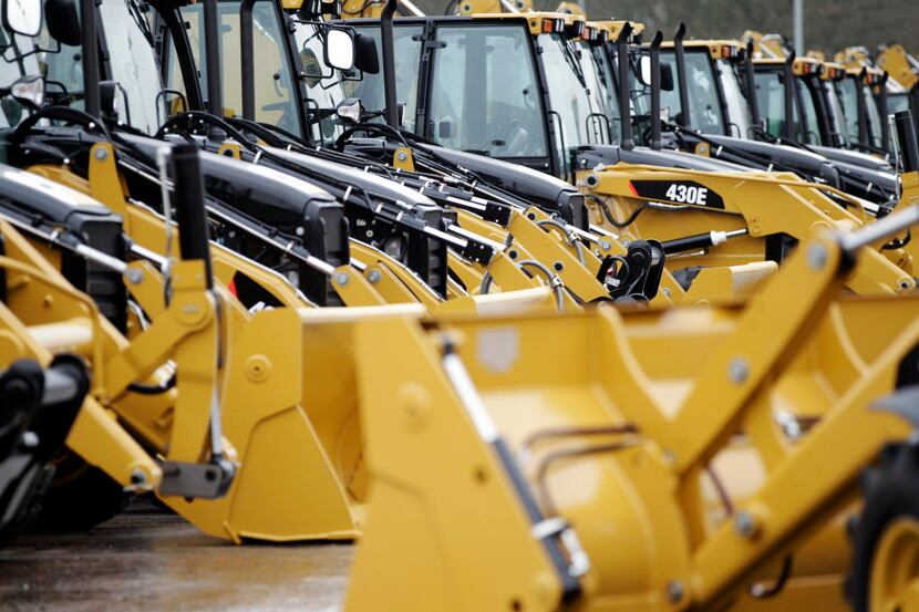 Newly manufactured Caterpillar Inc. 'backhoe' diggers are parked ready distribution at the...