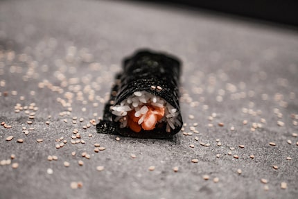 Handrolls are small, hand-held sushi rolls with raw fish and warm rice inside seaweed.