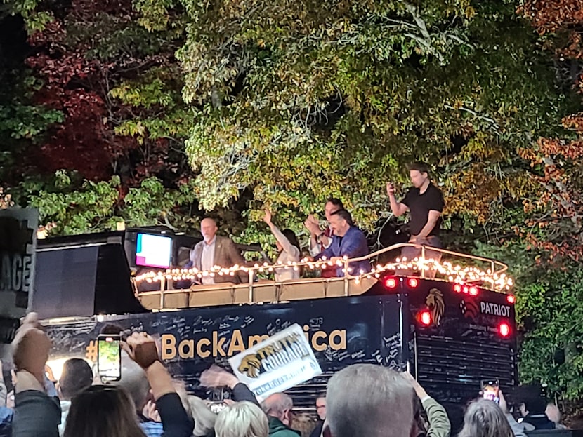 Sen. Ted Cruz, in blue, acknowledges the crowd as he arrives in Dumfries, Va., on Oct. 24,...