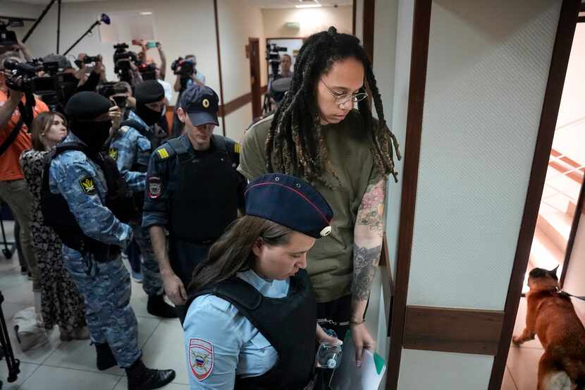 WNBA star and two-time Olympic gold medalist Brittney Griner is escorted in a court room...