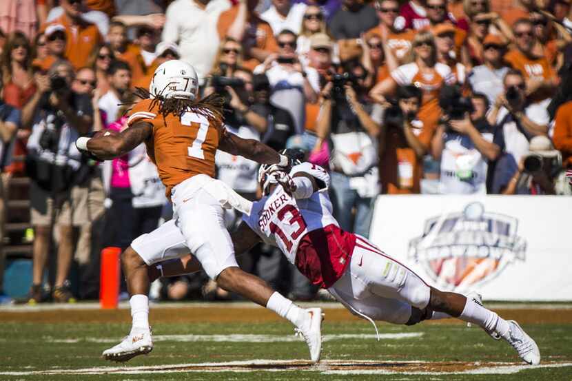 Texas wide receiver Marcus Johnson (7) gets past Oklahoma safety Ahmad Thomas (13) on a...