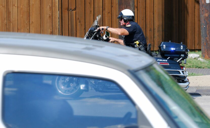 Garland police officer Lanny Orman chases a motorist for texting on their phone while...