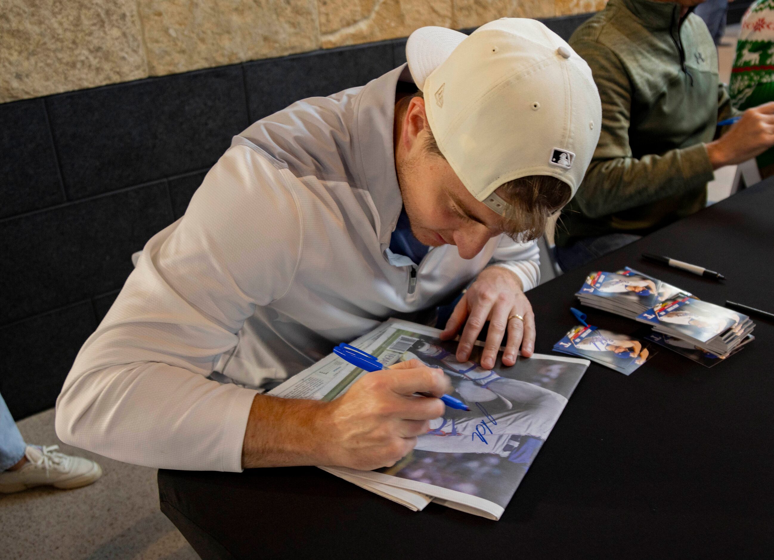 Texas Rangers relief pitcher Josh Sborz (66) signs a Dallas Morning News World Series...