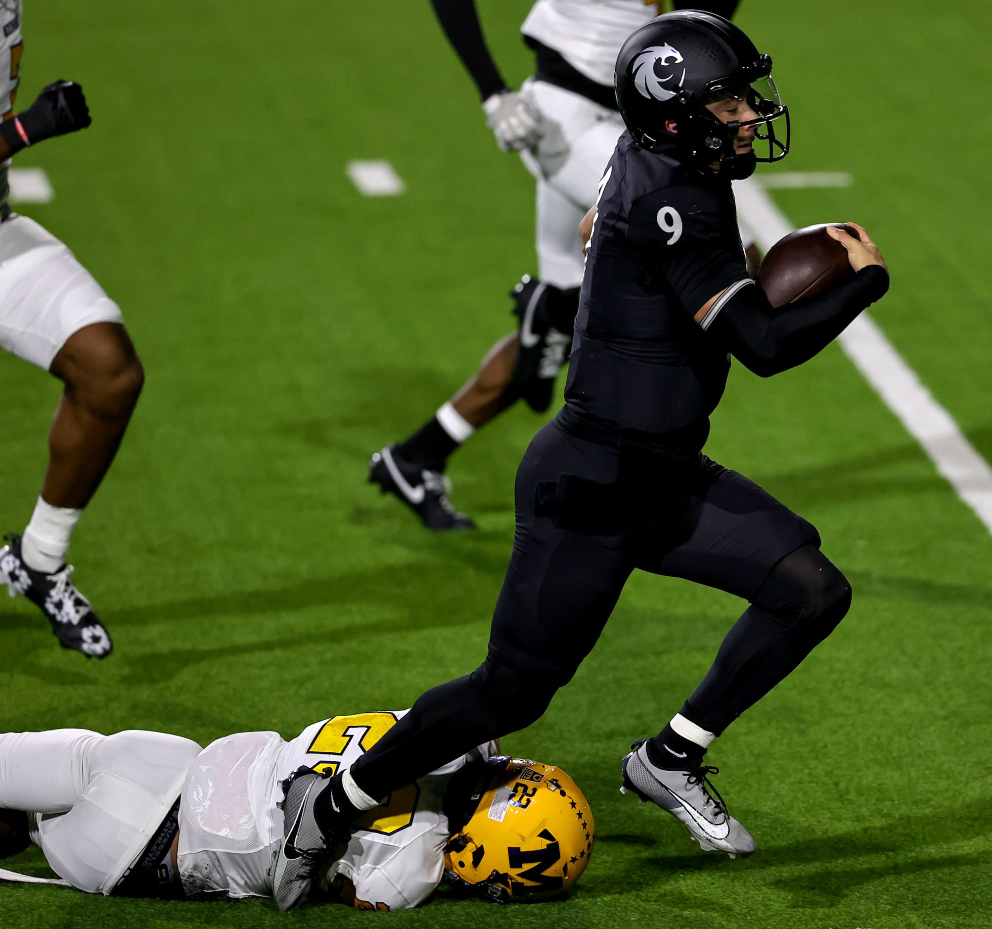 Denton Guyer quarterback Kevin Sperry (9) goes 37 yards and is finally brought down by...