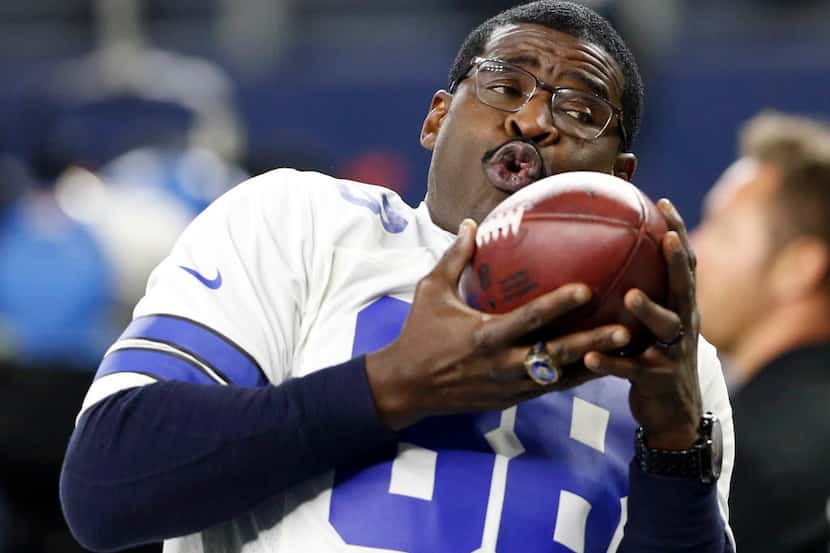 Dallas Cowboys former receiver Michael Irvin (88) plays catch with himself after being...