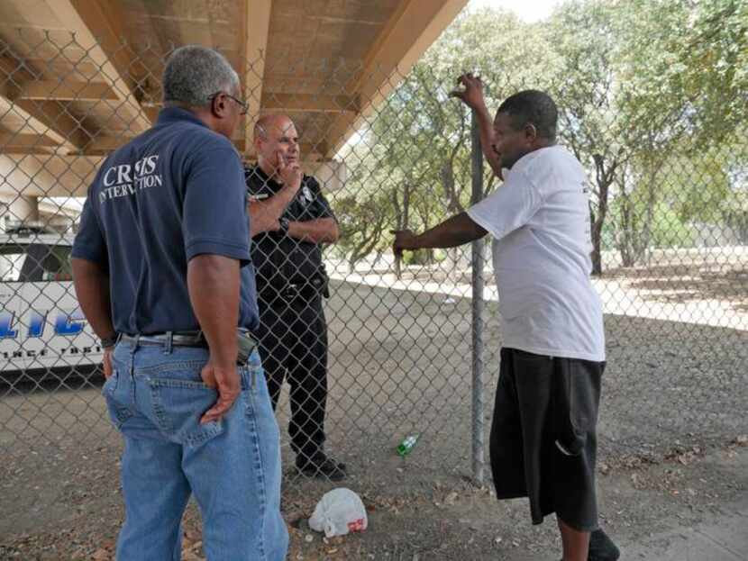 
A crisis intervention team member and a Dallas police officer talk with a homeless man. For...