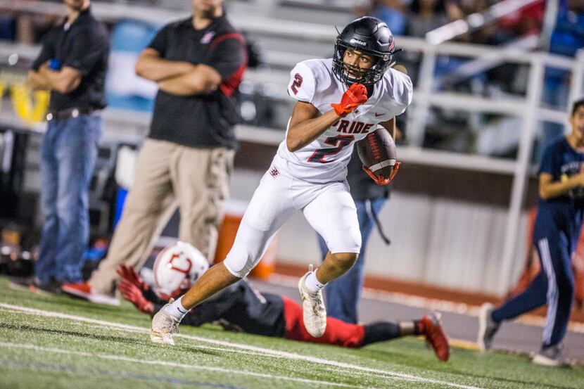 Colleyville Heritage wide receiver Kam Brown (2) hauls in a pass past Carrollton Creekview...