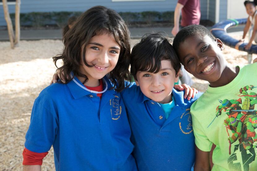 three school children with smiles