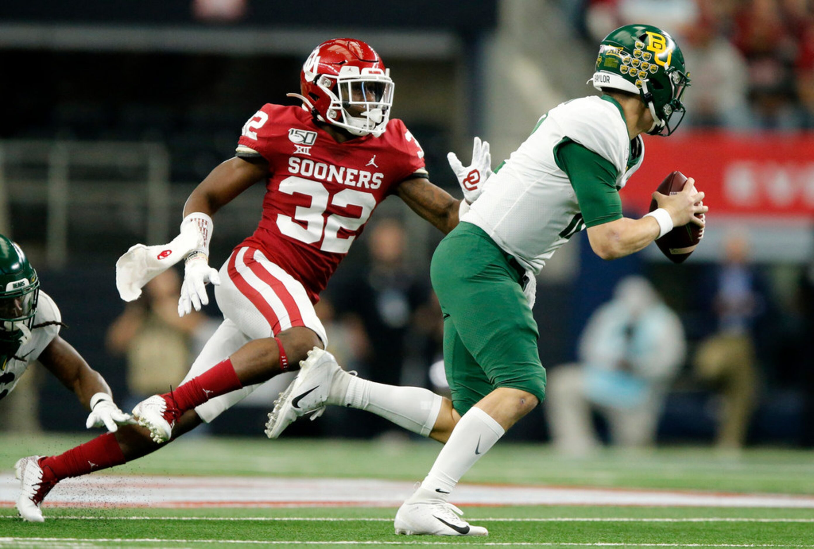 Baylor Bears quarterback Charlie Brewer (12) is chased from the pocket by Oklahoma Sooners...