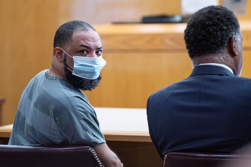 Prisoner Curtis Bullock looks over his shoulder as a witness walks into the 256th District...