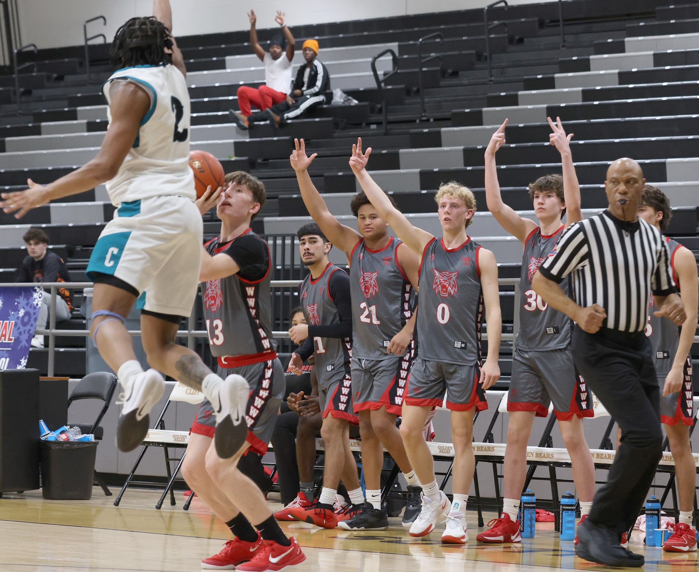 Dallas Woodrow Wilson's Michael Best (13) launches a long shot in front of his team bench as...