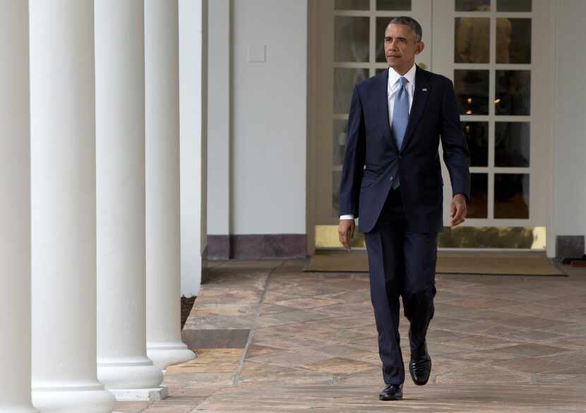 President Barack Obama walks along the colonnade of the White House in Washington.