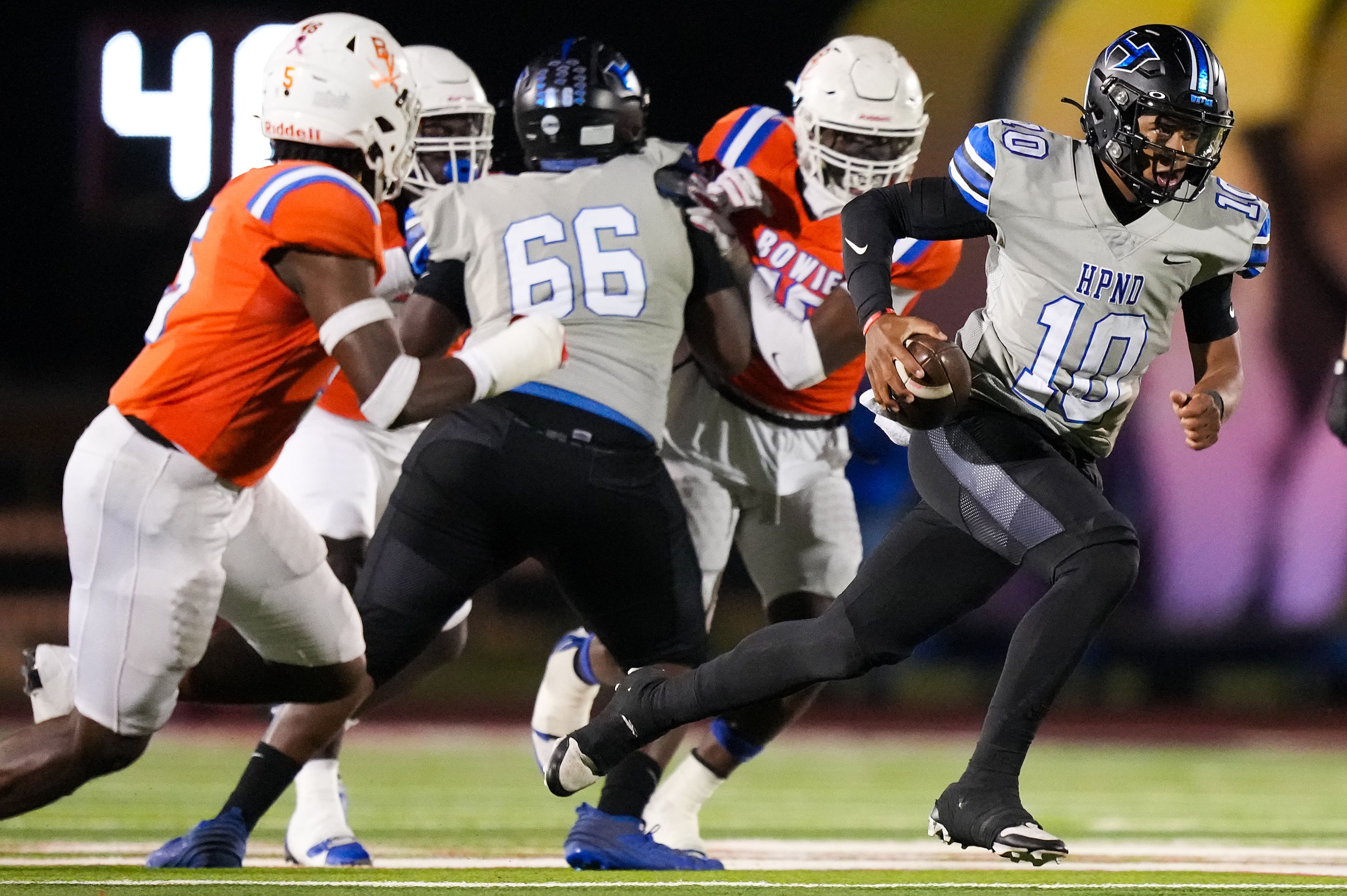 Hebron quarterback Patrick Crayton Jr. (10) breaks through the Arlington Bowie defense...