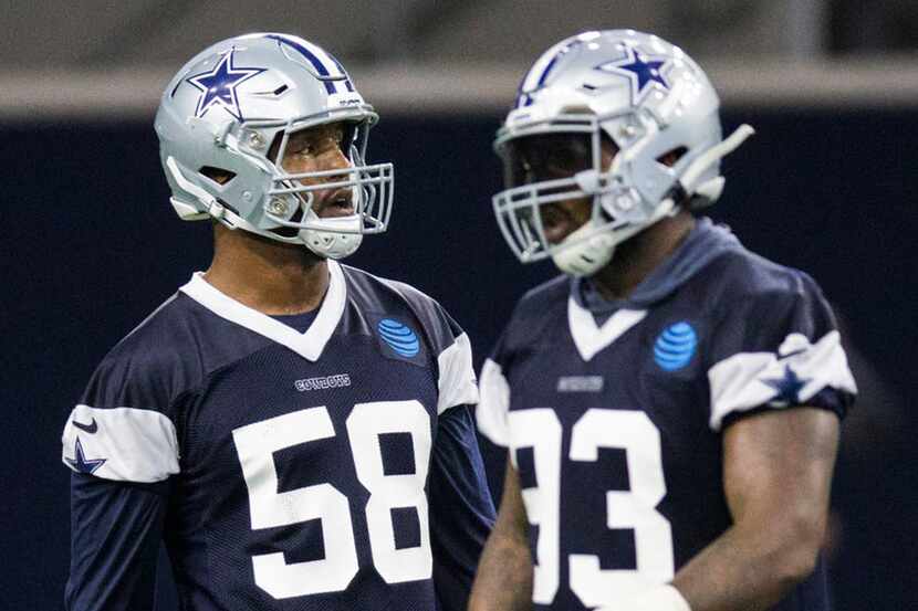 Cowboys defensive end Robert Quinn (58, left) participates in OTAs on Wednesday, May 22,...