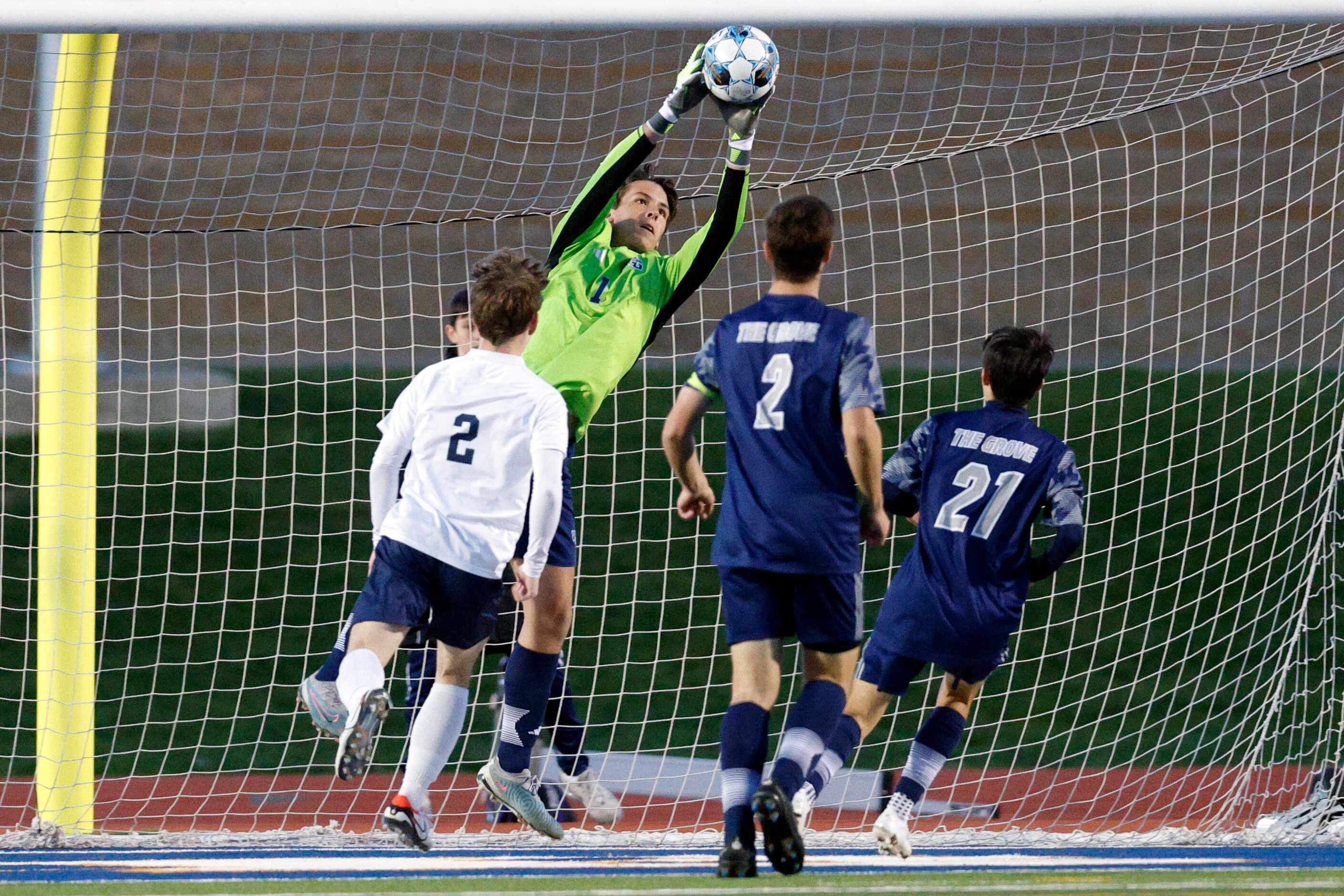 Prosper Walnut Grove goalkeeper Quinn Shelton (1) makes a leaping save near Frisco Reedy's...