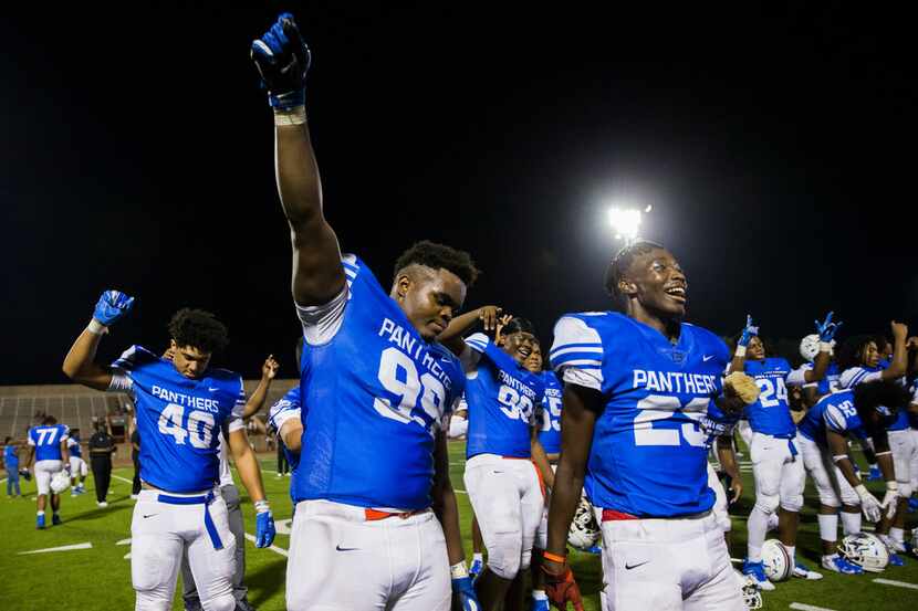 Duncanville defensive lineman Quincy Wright (99) lifts his fist as his team celebrates a...