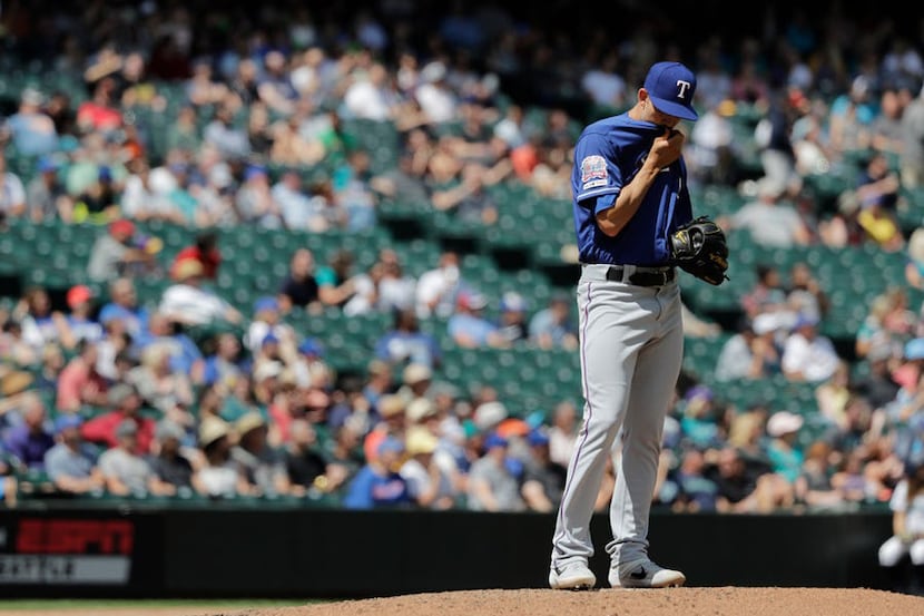Texas Rangers starting pitcher Mike Minor (23) stands on the mound during the fifth inning...