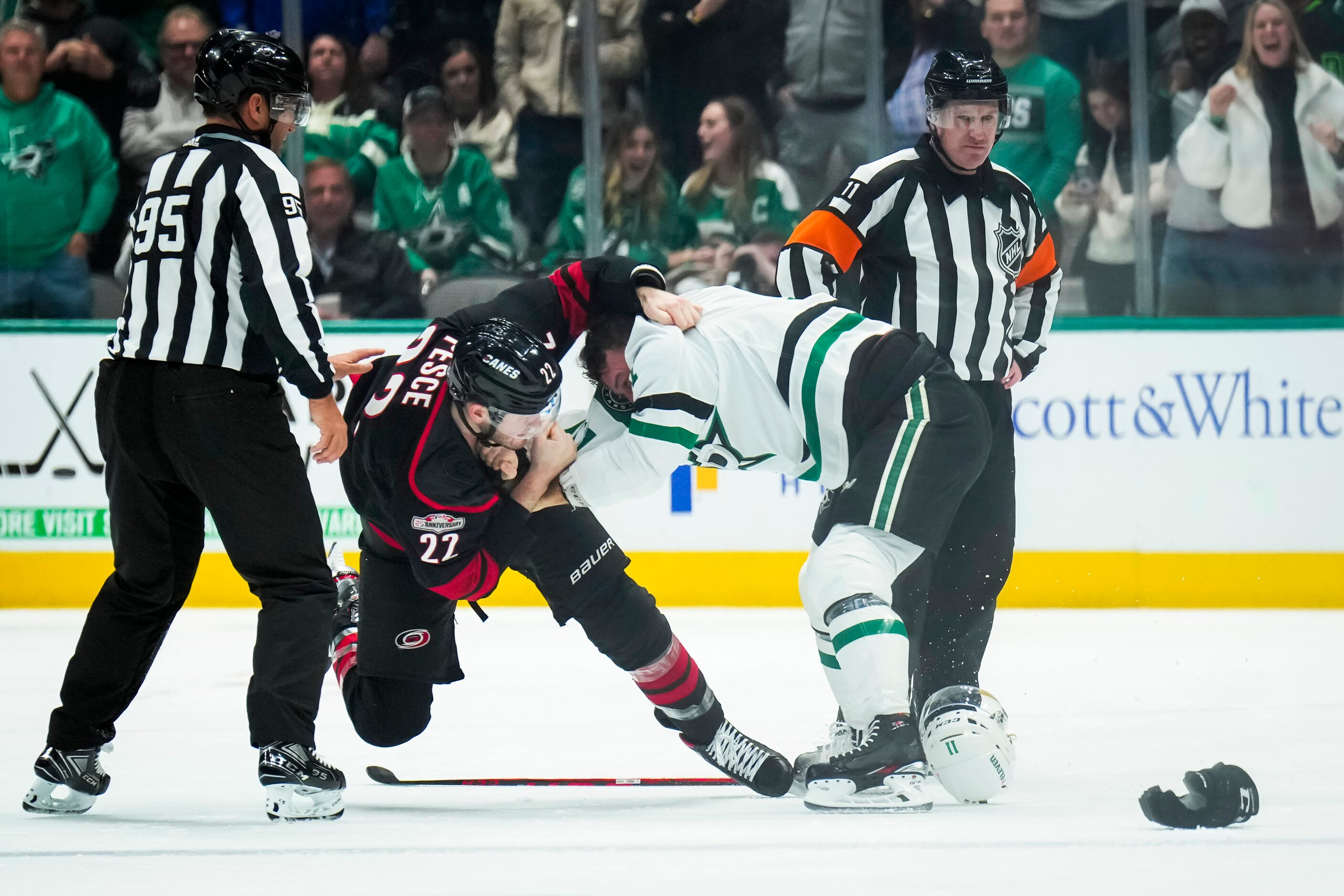 Dallas Stars center Luke Glendening (11) fights Carolina Hurricanes defenseman Brett Pesce...