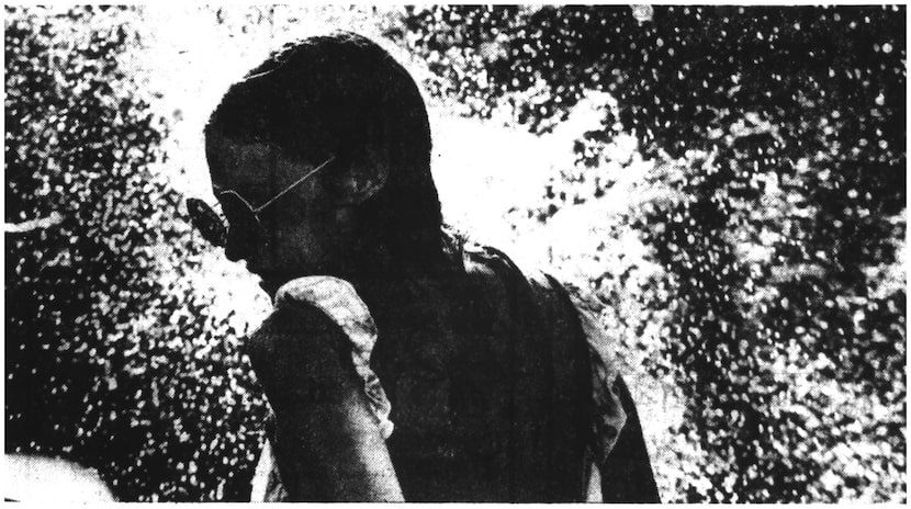 A concertgoer gets doused with a cooling splash of water during the Rolling Stones' July 6,...