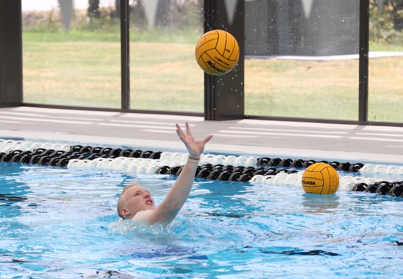 Blane Duplissey reaches to pull in a pass from a teammate. Members of the newly formed girls...