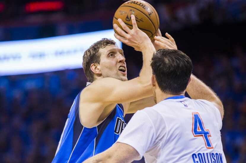 Dallas Mavericks forward Dirk Nowitzki (41) goes up for a shot over Oklahoma City Thunder...