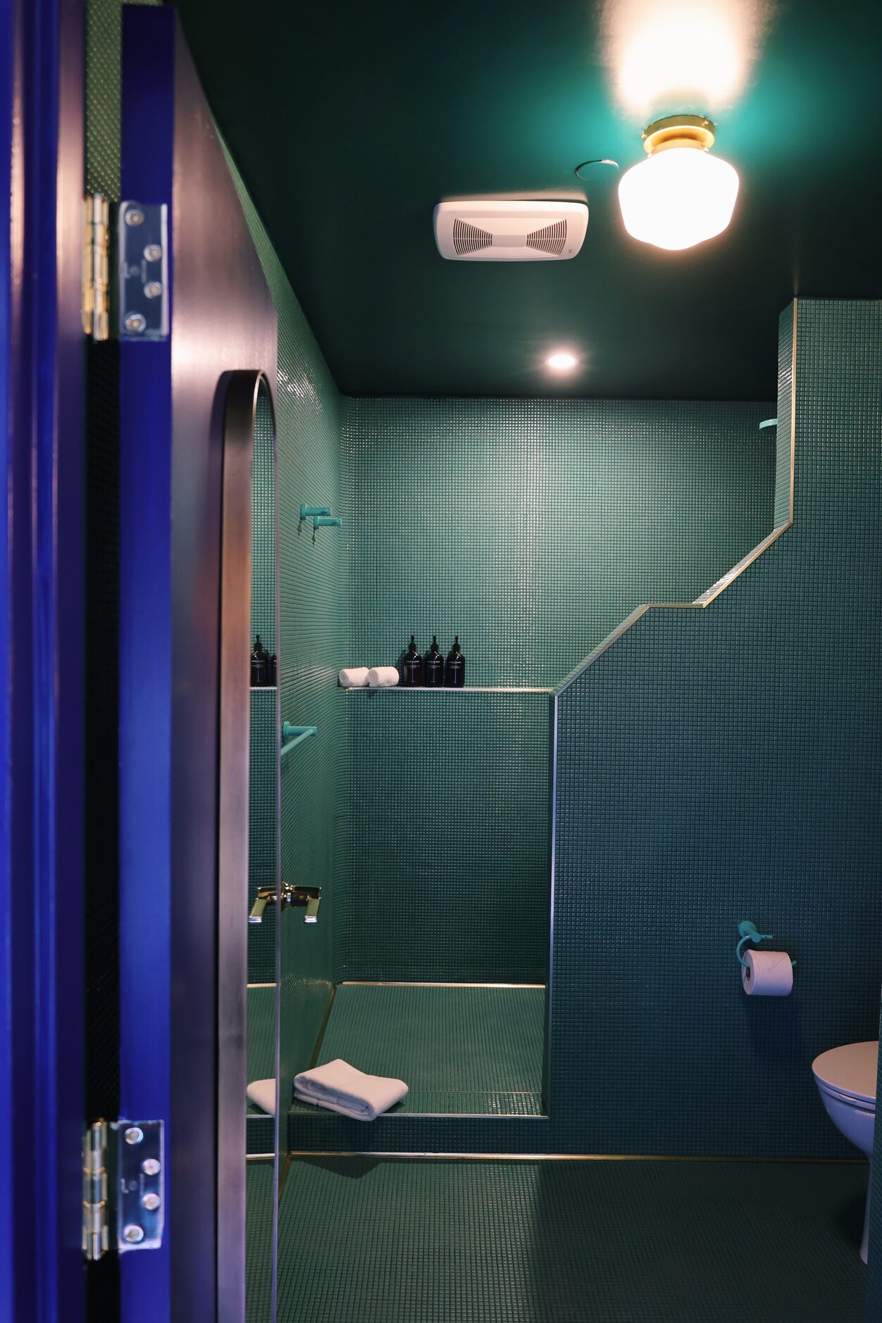 The bathrooms at Hotel Herringbone are monochromatic, designed floor to ceiling with tiny...