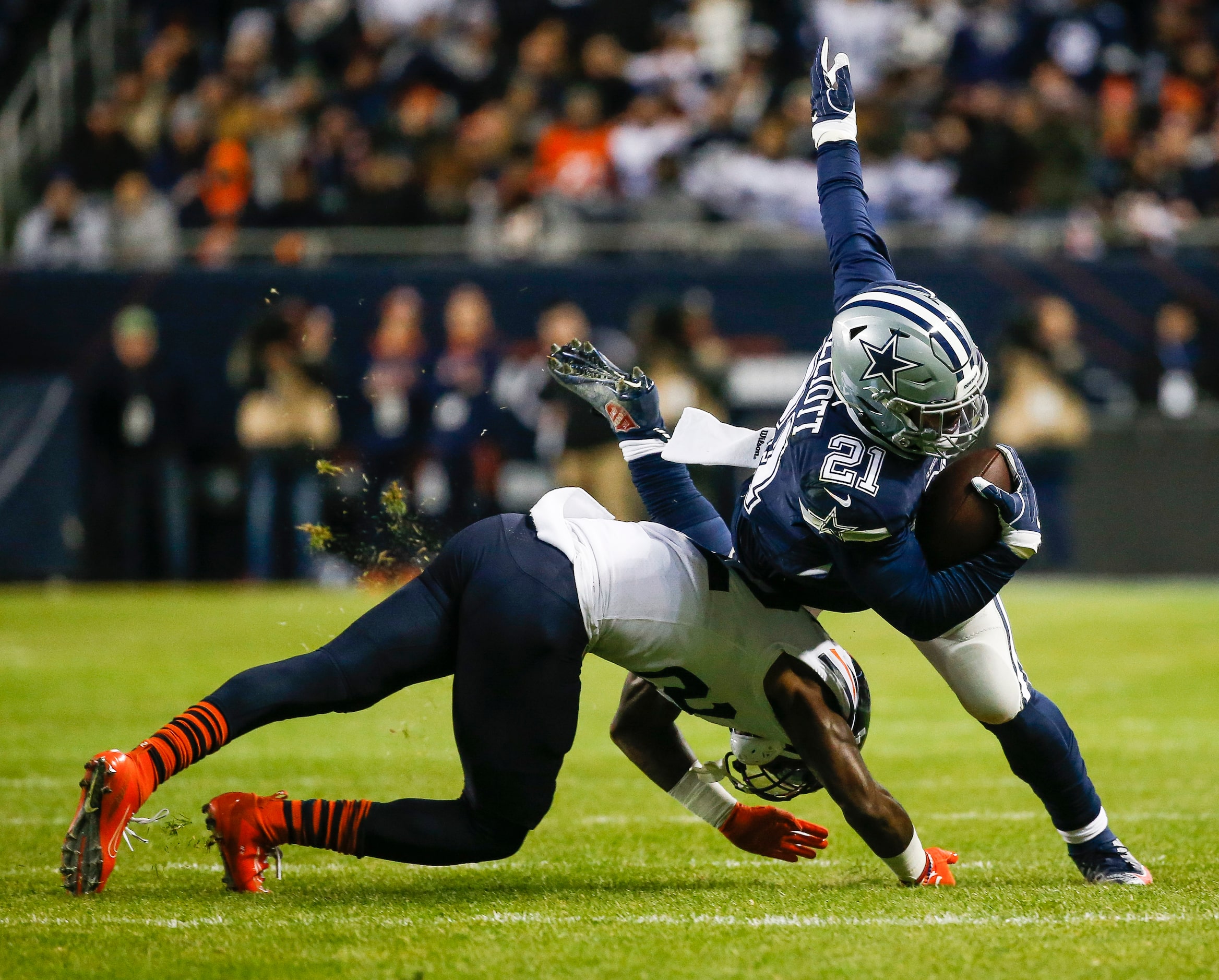 Dallas Cowboys running back Ezekiel Elliott (21) is brought down by Chicago Bears defensive...